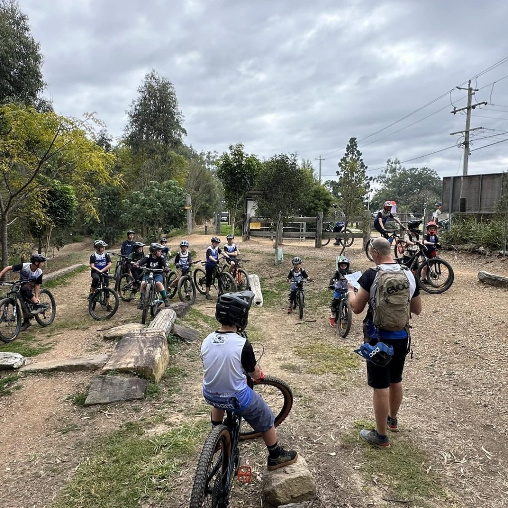 Coach briefing a group of young riders at the start of a school holiday clinic