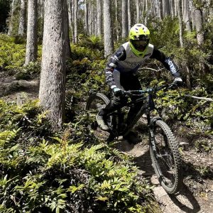 Advanced Development rider descending forest singletrack through tall gums