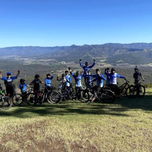 Bike On riders celebrating at a mountain lookout on a road trip