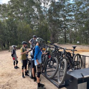 Riders loading their bikes onto the shuttle trailer at Wooroi