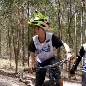 Two Bike On race team riders sharing a laugh on a forest trail